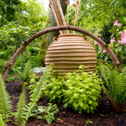 Ornamental pot surrounded by greenery.